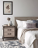 Suitcase-shaped bedside table in the bedroom in soft colours
