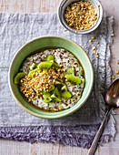 Almond and flax seed porridge with coconut milk and kiwis