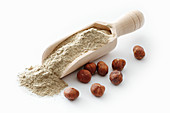 Hazelnut flour in a wooden scoop