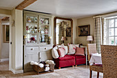 Vintage dresser, red velvet two-seater sofa and mirror