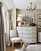 Antique chair next to chest of drawers in bedroom