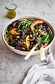 Quinoa lentil salad with rucola, roasted beets, pumpkin, apple, and red onion