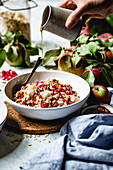 Oatmeal with apple, cinnamon, pecans, and pomegranate for breakfast