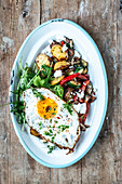 Fried vegetables with potatoes and fried egg