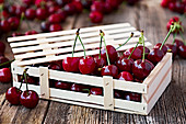 Wooden box with delicious ripe cherry