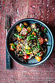 Aubergine salad with tomatoes and sesame seeds (seen from above)