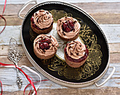 Vegan chestnut and chocolate cherry cakes on a vintage platter
