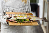 Girl Holding Whole Stuffed Rainbow Trout