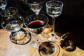 Various wine and liqueur glasses on a wooden background