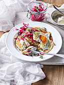 Buckwheat pancakes with red cabbage sauerkraut and fried egg