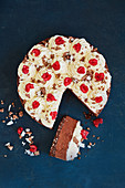 Chocolate mousse cake with coconut, cream and raspberries