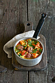 Peanut and sweet potato stew with salsicca