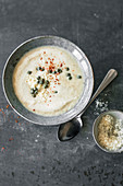 Cauliflower and almond soup with raisins and capers