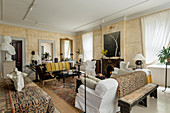 Large living room with original fireplace and furnished with an eclectic mix furniture and artwork