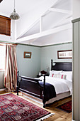 Bedroom with wooden bed in a converted barn