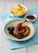 Duck leg with plums and polenta