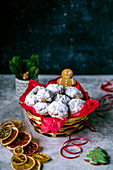 Mini stollen in a straw basket, gingerbread and chips from oranges and lemons