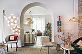 Festively decorated living room with open archway leading into dining room