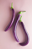 Japanese aubergines on a pink surface