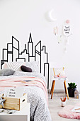 DIY skyline as bed head in the bedroom with pink accents