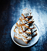 A Christmas tree made from different sized star-shaped biscuits with icing