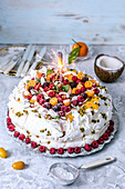 Pavlova cake with frozen berries and coconut