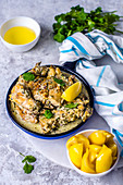 Chicken in a garlic-cream sauce in a ceramic pan and pickled lemons (One pot dish)