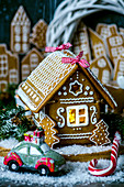 Hand made gingerbread house, in the background gingerbread city