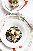 Herring on beluga lentils with apples and cranberries