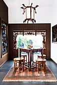 Asian tea room with antique furniture and decorative window frames