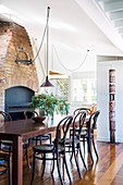 Dining area in front of a rustic fireplace