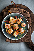 Sole rolls with aromatic crumbs, bacon and cheese