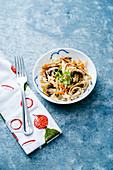 Asian egg roll cabbage salad bowl with carrots and mushrooms, topped with sliced green onions