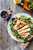 Marinated tofu salad with spicy peanut vinaigrette, sliced jalepenos, carrots, red onion and almonds