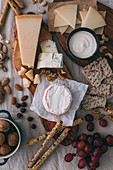 Cheese plate with nuts, grapes and bread