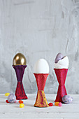 Easter eggs in eggcups made from painted egg box sections