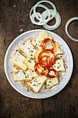 Cheese salad with romadur and onions on a wooden background