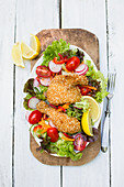 Fried chicken on a mixed salad