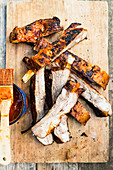 Spareribs with BBQ sauce on a wooden board