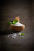 Coarse sea salt with a wooden spoon
