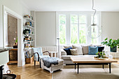Eclectic mixture of furniture in bright, Scandinavian-style living room