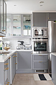 L-shaped fitted kitchen with pale grey cabinets