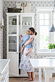 Mother and daughter stood in front of white cupboard