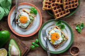 Savory waffles with mashed avocado and fried eggs