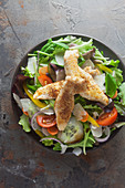 Mixed salad with chicken breast strips (top view)