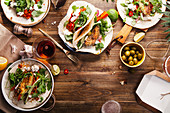 Tacos with fried avocados, tomatoes and greens