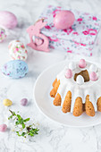 Easter cake with icing and candy sugared eggs