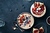 Blueberry banana smoothie bowl with figs and almond milk bowl with strawberries