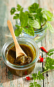 Coriander and mint dip with garlic and chilli in a jar