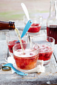 Wheat beer punch with raspberry syrup and raspberries